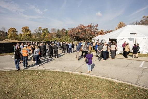 Trace groundbreaking crowd.